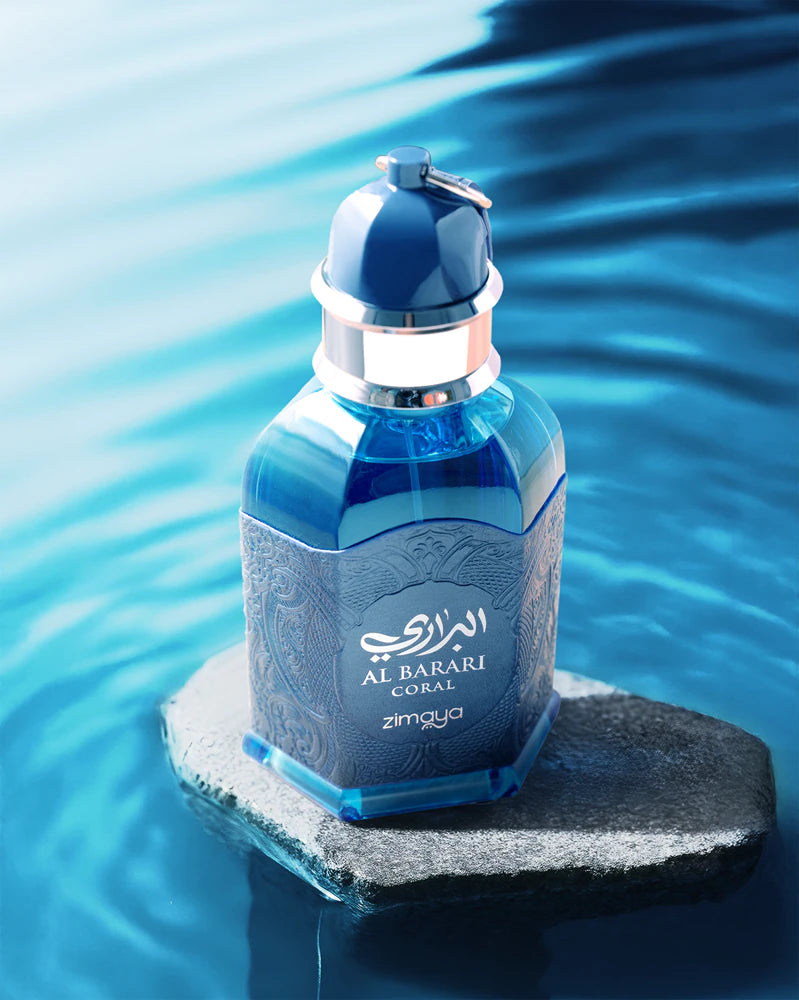 Blue perfume bottle on a rock with water in the background