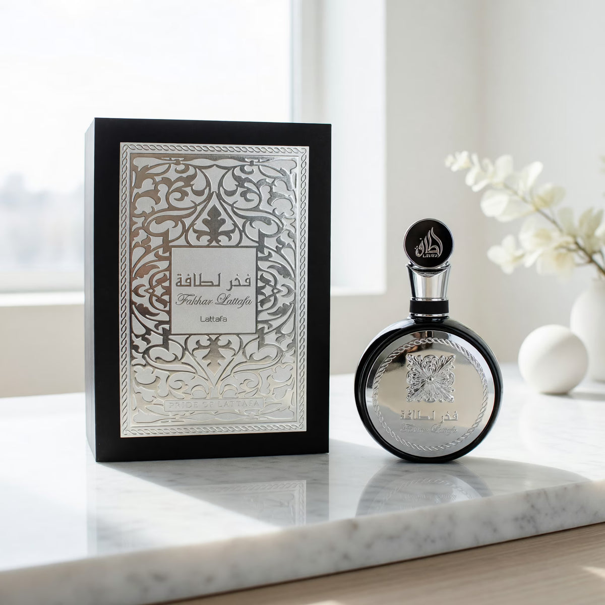 Fakhar Lattafa Silver fragrance – box and bottle on marble surface