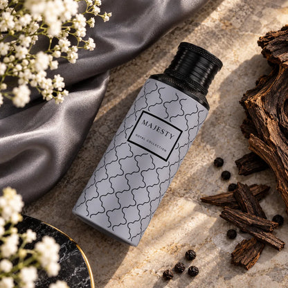 Majesty fragrance – bottle with white flowers, dark wood and black pepper on stone
