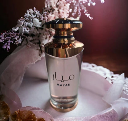 Mayar fragrance – bottle with floral arrangement lifestyle