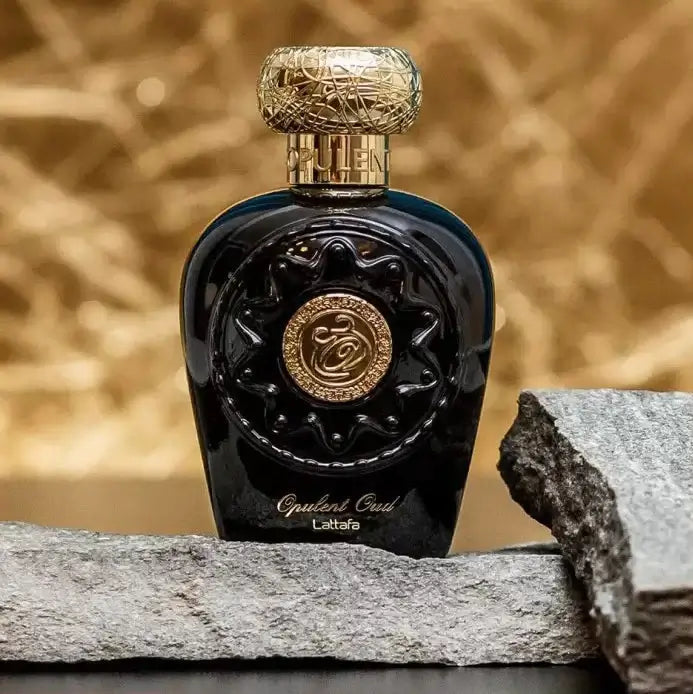 Opulent Oud fragrance – bottle on rock with warm golden light