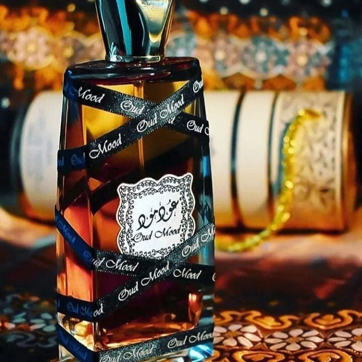 Oud Mood fragrance – bottle with oriental decorative backdrop warm amber tones